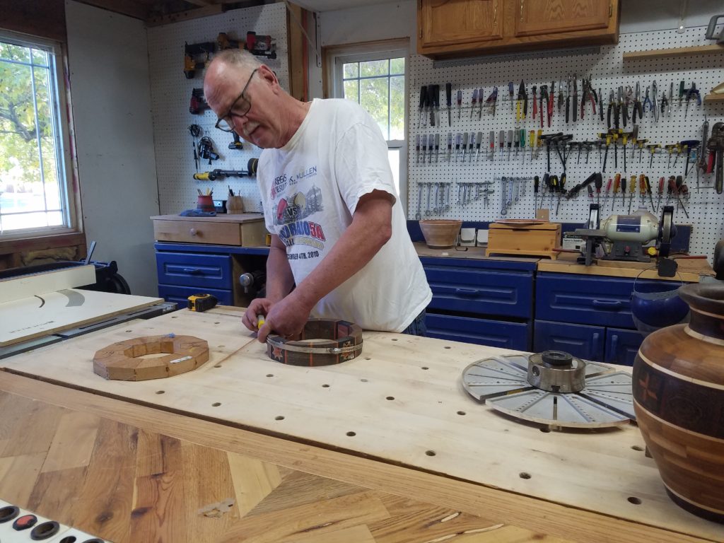 Dennis working in the woodshop without a dust mask.